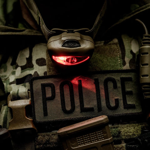 Vizz Tactical LED Headlamp 550 Lumen Power IPX7 Waterproof seen on police vest with red light in dark setting