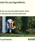 Person applying Ant Adios Outdoor Bug And Ant Killer with Spinosad in garden, emphasizing easy yard insect control.