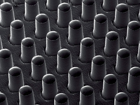 Close-up of GM630 Gripping Material Roll 24 Inch By 72 Yard Grey With Nylon Backing, showing textured thermoplastic elastomer surface.