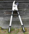 Double Ratcheting Anvil Lopper With Extendable Handles 26 To 40 Inches, lean against wooden shed, rugged rubber grips