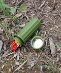 3 In 1 Green Waterproof Match Storage Box With Signaling Mirror And Firestarter Flint open in grass
