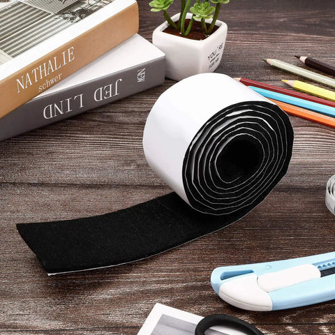 Two Pack Self Adhesive Felt Strips, Each About 59 Inches Long and 0.12 Inch Thick, rolled on a wooden table with supplies.
