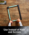 Person holding a frame using four 1 inch permanent mounting squares hold up to 1 pound total on contact no mess easy to use