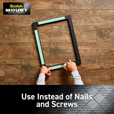 Person holding a frame using four 1 inch permanent mounting squares hold up to 1 pound total on contact no mess easy to use