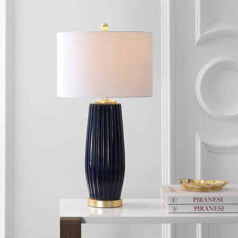 Navy Blue Modern Ceramic Table Lamp 28.5 Inches Tall For Living Room And Bedroom Fluted Bedside Nightstand Light With White Linen Shade And Gold Base LED Bulb Included For A Lit Vibe UL Listed standing on white tabletop.