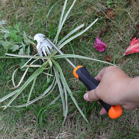 Hand using Weed Remover Tool With Rubber Handle Portable Garden Weeding Tool For Vegetable Gardens Backyards And Small Farms Hollow Hoe Design