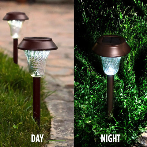 Bronze Solar Path Light Set Of 6 With Glass Lens And Metal Ground Stakes Plus Super Bright LED, daytime and nighttime view in garden.