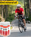 Cyclist on road with All In One Pro Grade Hydraulic Brake Bleed Kit With 180ml Mineral Oil bottles in foreground