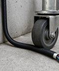 Built Tough Workhorse Corrugated Flexible Conduit Pipe With Compression Fitting Connector For Electrical Cable Routing And Wiring Harness Protection Rated At 20 Bar Pressure In A Sturdy 19 Millimeter Coil near a metal wheel.