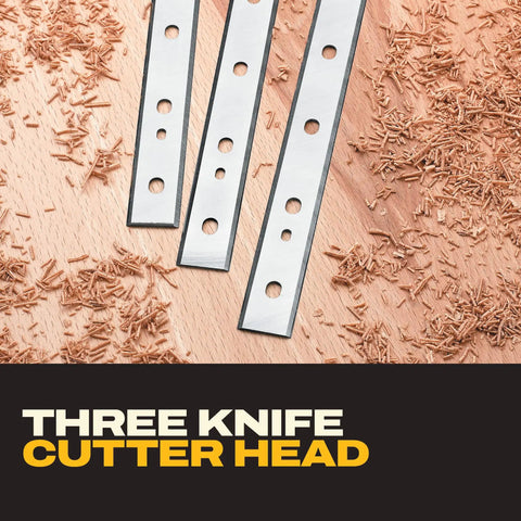 Three knife cutter head for Smoother Than Silk 13 Inch Benchtop Thickness Planer with wood shavings on a surface.