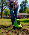 Person using 20V Cordless Garden Tiller Cultivator With 7.5 Inch Tilling Head, 2Ah Battery And Fast Charger Included, Green on lawn