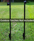Ground Spike Garden Stakes For Outdoor Lights Set Of 2 Steel Torch Stakes installed in grass, fits poles up to 1.25 inches