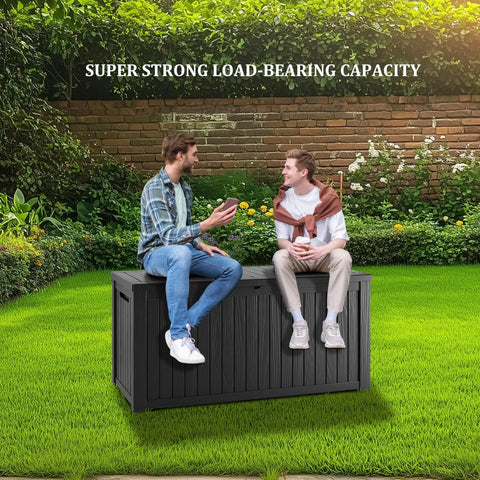 Two people sitting on a 200 Gallon Waterproof Outdoor Storage Box Built Tough Resin Deck Box in a garden
