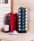 Heavy Duty Metal Pod Holder For Nespresso Vertuo Line, 80 Pod Capacity next to a red coffee machine on a kitchen countertop