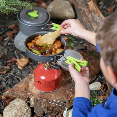 Child using Backpacking Cooking Kit 10 Piece Non Toxic Anodized Aluminum Camp Cookware Set Stove Compatible Durable Gear for Hikers and Scouts Perfect for Solo Trips outdoors