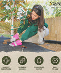 Woman installing Heavy-Duty Weed Barrier Fabric 4 By 100 Feet Breathable Woven Polypropylene for landscaping and gardening.