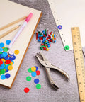 All In One Dope Craft Fasteners Set From Mudder With 100 Brass Paper Fasteners And 300 Colorful Washers Plus 1 Hole Punch For Scrapbooking DIY Projects And School Supplies shown with paper and tools.