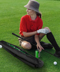 Person sitting on grass next to Seven Can Insulated Beer Sleeve Sling For Golf Bags Waterproof 600D Oxford Cooler With Thermal Insulation