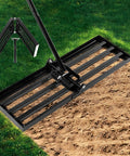 Foldable Lawn Leveling Rake with 72 Inch Adjustable Handle and Detachable Carbon Steel Head on soil in garden