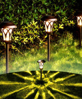 6 Pack Solar Pathway Lights Outdoor Set glowing in garden, durable metal, glass, and ABS build, IP65 waterproof landscape lights.