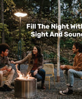People enjoying a fire pit under Cordless Outdoor Solar Floor Lamp With Bluetooth Speaker No Wires Needed For Patios And Decks Weatherproof All Weather Outdoor Space 100 Percent Solar Powered Firefly Two Point Zero Light And Sound in a forest setting.