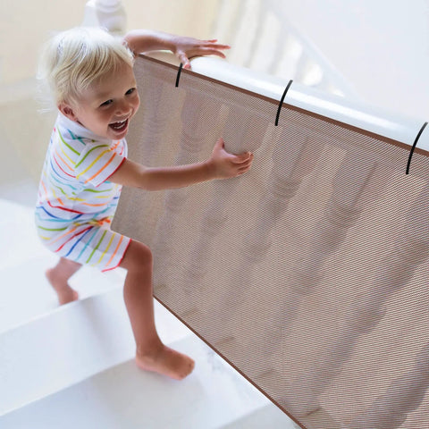 Toddler using Two Pack Brown Baby Banister Guard Net For Stairs And Balconies, Kid And Pet Safe Stair Netting, 30 Feet By 3 Feet