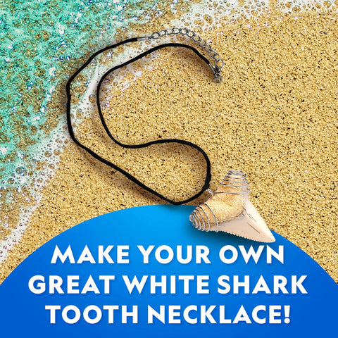 Shark Tooth Dig Kit Excavate Replica Fossils with shark tooth necklace on sand, educational STEM kit for kids ages 6 to 8.