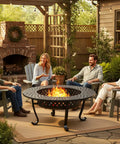 Three In One Extra Large Outdoor Fire Pit Table for Backyard Hangouts with two removable grill plates and fire poker, 43-inch round table in use by group of friends