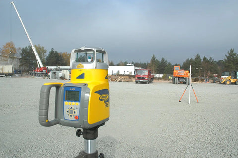Beast Dual-Slope Grade Laser Level Kit With HL760 Meter on construction site with cranes and vehicles in background.