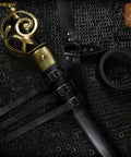 Genuine Leather Sword Baldric Belt For LARP And Renaissance Costumes on chainmail background, black leather with brass accents.