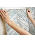 Applying Herringbone Blue And Tan Wood Boards Peel And Stick Wallpaper Roll Twenty Point Five Inches Wide By Sixteen Point Five Feet Long
