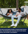 Couple relaxing on DoubleLoft Hammock Chair for Two Cozy and Comfortable With Cushioned Arm and Leg Rests, Side By Side Seating