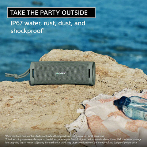 Ultimate Field 1 Waterproof Portable Bluetooth Speaker With Dope Bass And 12 Hour Battery Life IP67 Dustproof Shockproof Rustproof Detachable Strap SRSULT10D Orange on a rock near the sea