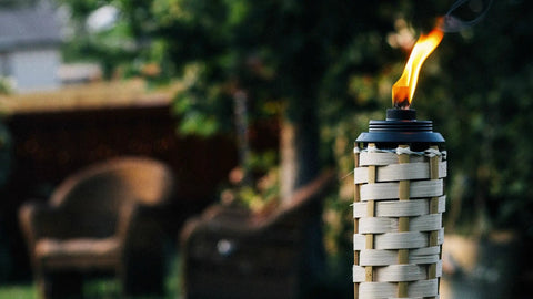 12 Oz Torch Replacement Canister With Easy Pour System For Outdoor Patio Torches Mess Free Refills Burns Up To Five Hours Per Fill Long Lasting Fiberglass Wick Fits Most Metal Torch Bases on a patio