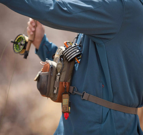Vertical Fly Fishing Chest Pack With Zippered Main Compartment And Interior Pocket Low Profile Tidal Blue in use while fishing