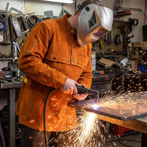 Welder in workshop wearing Leather Welding Jacket With Open Back And Cape Sleeve, Bib Apron Style Welder Coat in medium size
