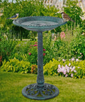 28 Inch Height Polyresin Bird Bath With Antique Verdigris Finish, Weather Resistant Pedestal Garden Decor, Fleur De Lys Accent Bowl, installed in garden with birds