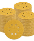 Get These Sweet 5-Inch 80 Grit Sanding Discs For Woodworking Or Cars Plus Hook And Loop Design Makes Them A Durable Tool Kit Essential Anyone Can Rock Fast And Easy - Stacks of yellow sanding discs with holes.