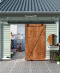 Exterior Sliding Barn Door Hardware Track Kit With 96 Inch Black Track, Heavy Duty 500 Lb Capacity, Weatherproof Wall Mount System For Outdoor Use, Includes Five Brackets, Door Not Included installed outside a green building