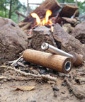 Hickory Fire Piston Kit With Char Cloth O Rings Instructions And Storage Bag For Quick Campfire Lighting Primary Or Backup Fire Starter Air Powered Tool Made In USA Reliable Durable on ground near campfire