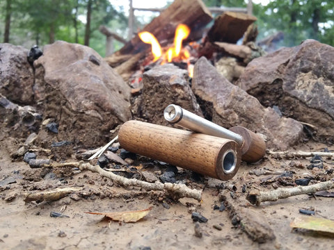 Hickory Fire Piston Kit With Char Cloth O Rings Instructions And Storage Bag For Quick Campfire Lighting Primary Or Backup Fire Starter Air Powered Tool Made In USA Reliable Durable on ground near campfire