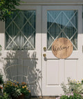 Six Round Sublimation Door Hanger Blanks For DIY Wall Decor displayed on white door with "Welcome" text, enhancing entryway.