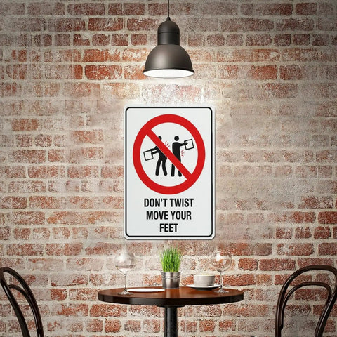 Dont Twist Move Your Feet Safety Instruction Sign 8x12 Aluminum on brick wall in industrial setting