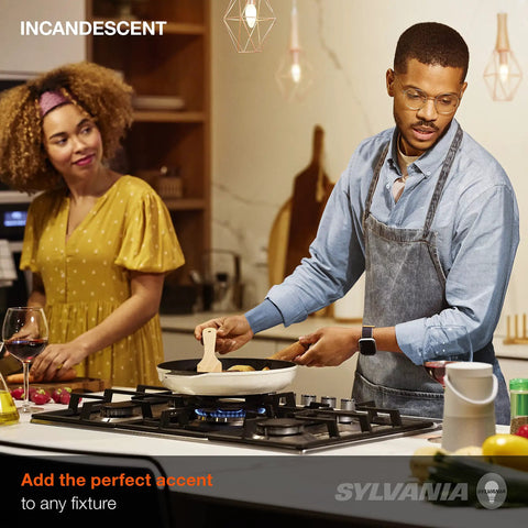 Couple cooking in kitchen with Long Lasting 25W B10 Candelabra Base Light Bulbs for enclosed fixtures and chandeliers visible above.