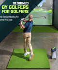 Golfer practicing swing on Elite 5x5 Ft Golf Hitting Mat With 15mm Artificial Turf in indoor simulator.