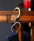 HeroClip Small Carabiner Clip And Hook Three In One for purses, strollers, and backpacks, hanging a bag on a table edge, stealth black.