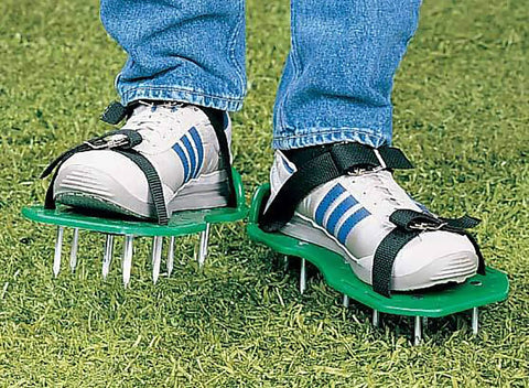 Person wearing Walkable Lawn Aerator Sandals For Healthier Grass, Easy Spike Shoes Open Hard Soil on grassy lawn.