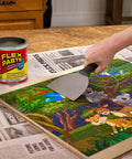 Person using a putty knife to apply Flex Paste on wooden surface with can in view, not related to waterproof paintable putty and spackle sealant.