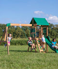 Children playing on Buckley Hill Cedar Wood Swing Set With Wave Slide, Elevated Play Deck, Rock Wall Ladder, Belt Swings, Canopy Roof.
