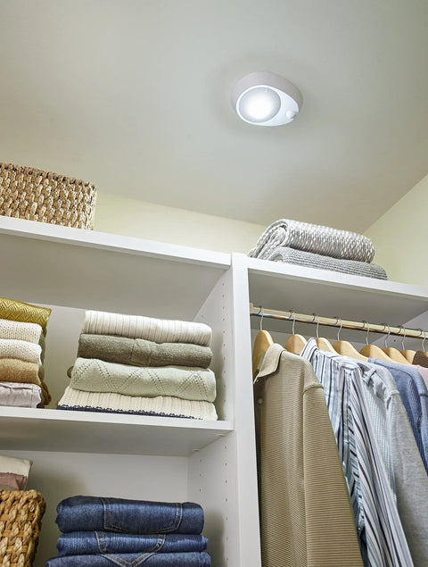 Motion Activated LED Ceiling Lampholder 8.7W 120VAC 9864-LED in closet, illuminating shelves with clothes.